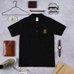 A black polo shirt with a yellow logo and some other items