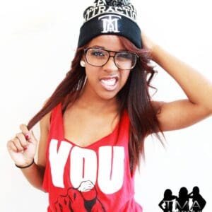 A woman wearing glasses and a hat with the words " you " on it.