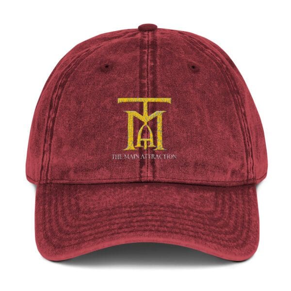 A maroon hat with the word " t " on it.